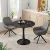 A round black dining table with two gray chairs in a well-lit room with a window and a cabinet in the background. Anteprima dell’immagine prodotto