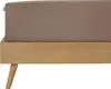 A close-up side view of a bed frame with a fitted sheet. Produktbild-Vorschau