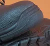 A close-up view of the sole and heel of a black work boot. Náhľad obrázku produktu