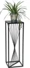 A black metal plant stand with a plant in a silver pot on top, isolated on a white background. Anteprima dell’immagine prodotto