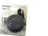 A bicycle bell in its packaging, with a model in the background. Produktbild-Vorschau