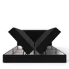 A black bed frame with the storage compartments open, revealing the internal storage space. Voir les images du produit