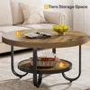 A round coffee table with two tiers, placed in a living room setting next to a sofa. Náhľad obrázku produktu