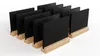 A set of small black chalkboards with wooden stands arranged in rows on a white background. Anteprima dell’immagine prodotto