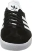 A front view of a black Adidas Gazelle sneaker with white stripes and sole. Náhled obrázku produktu