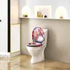 A toilet with a decorative seat in a modern bathroom setting. Produktbild-Vorschau