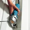 A hand holding a power tool cutting into a corrugated metal surface. Podgląd zdjęcia produktu