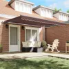 A patio area with a retractable awning, outdoor furniture, and a rocking chair. Podgląd zdjęcia produktu