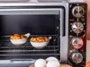 A countertop oven with food inside. Produktbild-Vorschau
