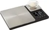 A KitchenAid dual platform stainless steel kitchen scale with a small bowl of white granular material on one of the platforms. Voir les images du produit