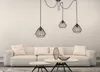 A modern living room with a white sofa and a black pendant light fixture. Produktbild-Vorschau
