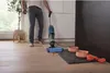 A person is using a wet and dry vacuum cleaner on a wooden floor in a kitchen setting. Podgląd zdjęcia produktu