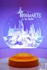 A 3D LED lamp shaped like Hogwarts castle, with the text 'Hogwarts is my home' and a Sorting Hat. Produktbild-Vorschau