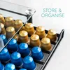 A close-up of a coffee capsule holder filled with gold and blue coffee capsules, with text overlay. Produktbild-Vorschau