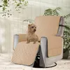 A dog sitting on a recliner chair covered with a beige protector. Anteprima dell’immagine prodotto