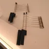 Two chrome toaster racks with black handles are mounted on a light-colored wall. Podgląd zdjęcia produktu