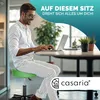A man is working on a laptop while sitting on a green adjustable stool in an office environment. Anteprima dell’immagine prodotto