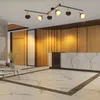 A modern reception area with a marble counter, wooden walls, and a track light fixture on the ceiling. Voir les images du produit