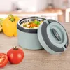 A lunch thermos with its lid open, filled with food, sits on a wooden table next to a yellow bell pepper and tomatoes. The background shows a blurred kitchen setting. Voir les images du produit