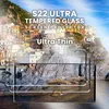 A scenic view of a coastal town with colorful buildings on a cliffside, with a product overlay showing a smartphone screen protector. Produktbild-Vorschau