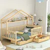A wooden children's house bed with storage drawers and bedding, set in a room with decorative items. Produktbild-Vorschau
