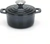 A dark gray cast iron pot with a silver lid handle sits on a white surface. Produktbild-Vorschau