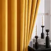 A close-up of yellow velvet curtains with decorative candles and books on a table. Anteprima dell’immagine prodotto