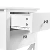 Close-up view of a white nightstand with one drawer pulled out. Podgląd zdjęcia produktu