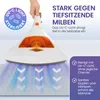 A hand holding a white and orange mattress cleaner with UV-C light shining on a mattress. Produktbild-Vorschau