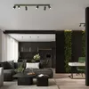 A modern living room and kitchen area with a sofa, coffee table, kitchen cabinets, and a vertical garden wall. Voir les images du produit