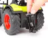 A close-up view of the back of a toy tractor, with a hand adjusting a part. Produktbild-Vorschau