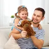 A father and daughter are playing with a stuffed toy on a couch. Produktbild-Vorschau