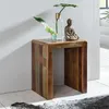 A wooden side table with decorative items on top, placed against a white wall. Podgląd zdjęcia produktu