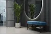 A modern entryway with a blue upholstered bench with shoe storage underneath, a large oval mirror with LED lighting, and a potted plant. Náhľad obrázku produktu