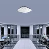 An office or lobby setting with people using laptops and a ceiling-mounted access point. Podgląd zdjęcia produktu