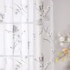 A close-up view of a sheer curtain with a floral pattern. Produktbild-Vorschau
