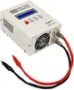 A white electronic battery tester with a blue display screen and various buttons, connected to red and black alligator clips via cables. The device has a fan on the side. Náhled obrázku produktu