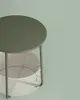 A close-up of a round green side table with a white basket underneath. Náhled obrázku produktu