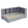A gray corner bed with built-in shelving and drawers. Produktbild-Vorschau