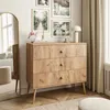 A wooden dresser with three drawers is placed in a room with artwork on the wall and a large mirror. Náhľad obrázku produktu