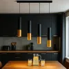 A modern kitchen scene with a dining table in the foreground and pendant lights above. Produktbild-Vorschau