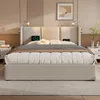 A modern bedroom with a beige upholstered bed as the main focus. Náhled obrázku produktu