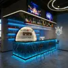 A modern bar with neon lighting and screens displaying entertainment. Anteprima dell’immagine prodotto