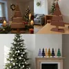 A collage of four images showing different Christmas tree decorations, including a wooden tree on a table, a wooden tree on a table, a decorated real Christmas tree, and a set of wooden trees on a mantelpiece. Anteprima dell’immagine prodotto