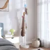 A bedroom scene with a bedside table, bed, and a coat rack. Anteprima dell’immagine prodotto