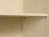 A close-up view of a shelf bracket and a wooden shelf in a cabinet. Produktbild-Vorschau