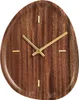 A close-up, front-facing view of a wooden wall clock with gold hands and hour markers. Voir les images du produit