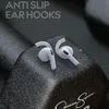Two white earbud tips with ear hooks are placed on a textured black surface, with water droplets on them. Produktbild-Vorschau