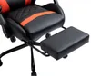 A close-up view of a black and orange gaming chair with an extended footrest. Anteprima dell’immagine prodotto
