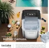 An ice maker is shown on a table next to drinks and fruit, with a pool in the background. Produktbild-Vorschau